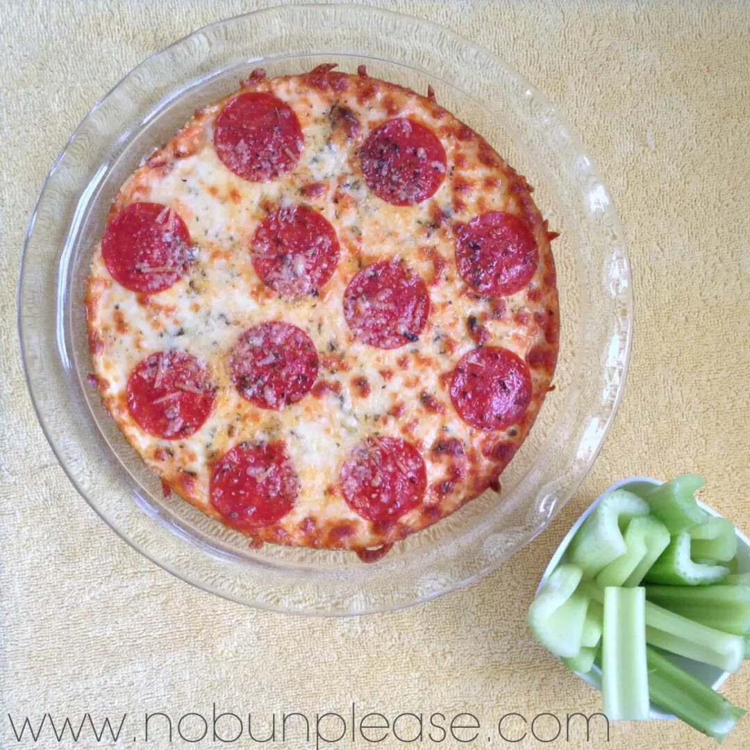 Creamy and zesty pizza dip that is topped with melted cheese and pepperoni. You won't miss the crust!