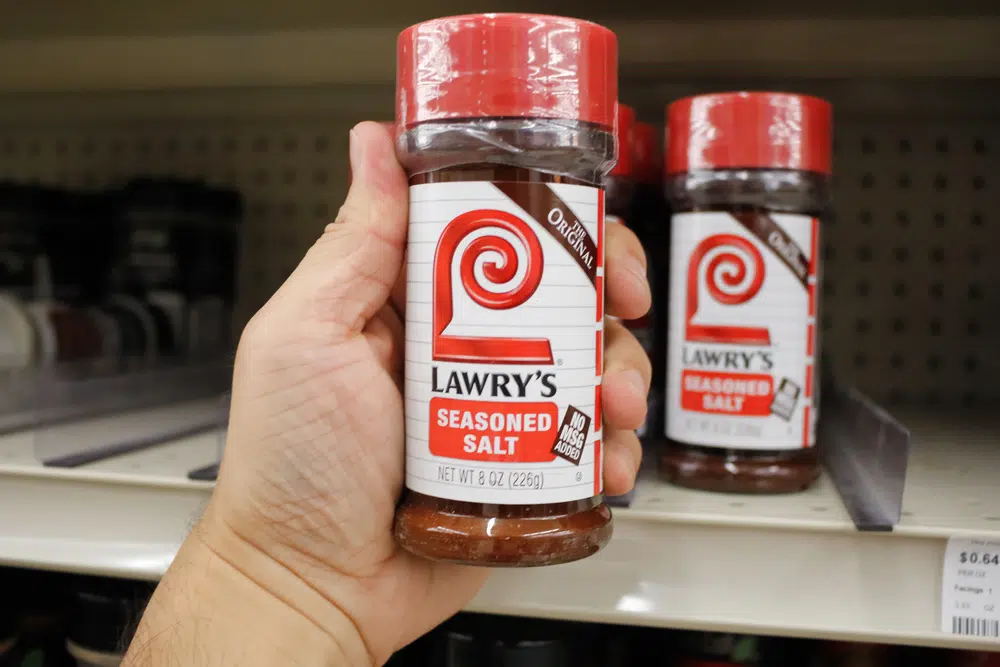 A Hand Holds A Container Of Lawry's Season Salt