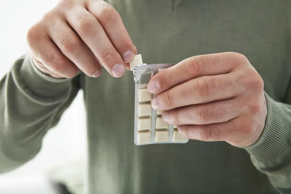 Man With His Blister Pack Of Nicotine Gum