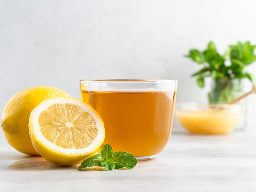 A Cup Of Fresh Green Herbal Tea With Lemon, Honey And Green Mint Leaves