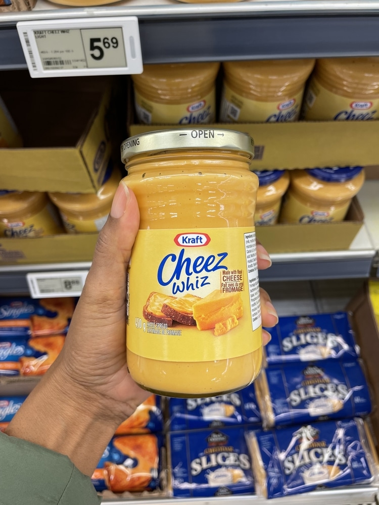 A Person Holding A Jar Of Kraft Cheez Whiz