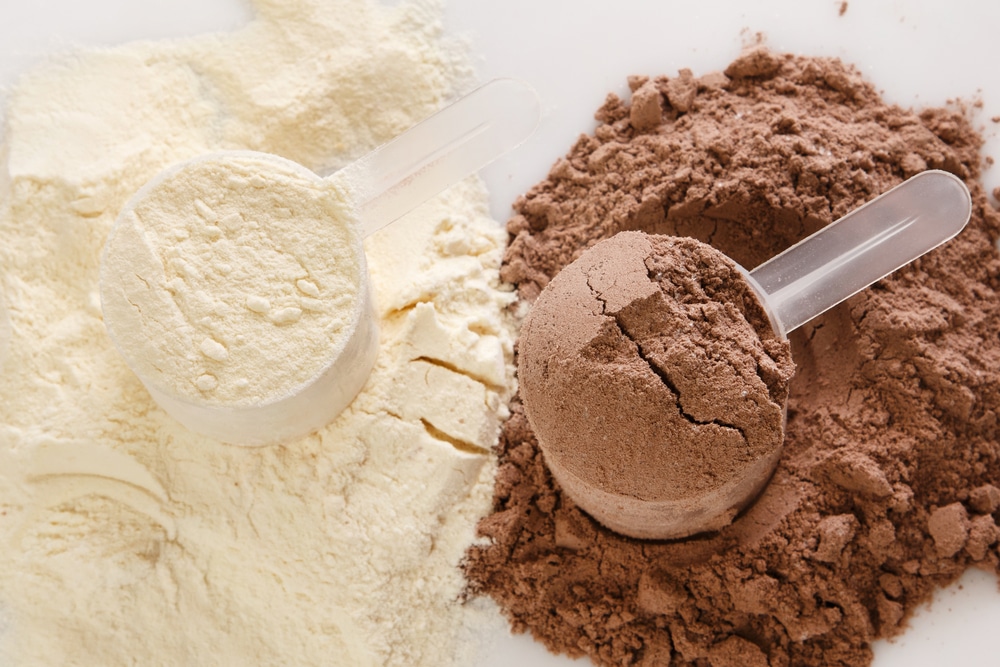 Close Up Of Protein Powder And Scoops