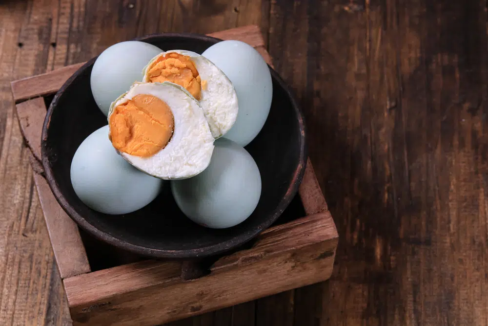 Homemade salted eggs served in a wooden box