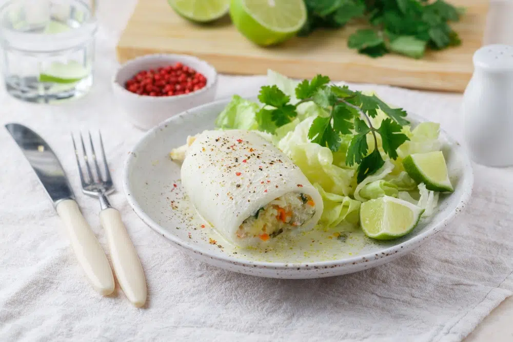Squid Stuffed With Rice, Carrots, Onions And Herbs In A Creamy Sauce With Cilantro