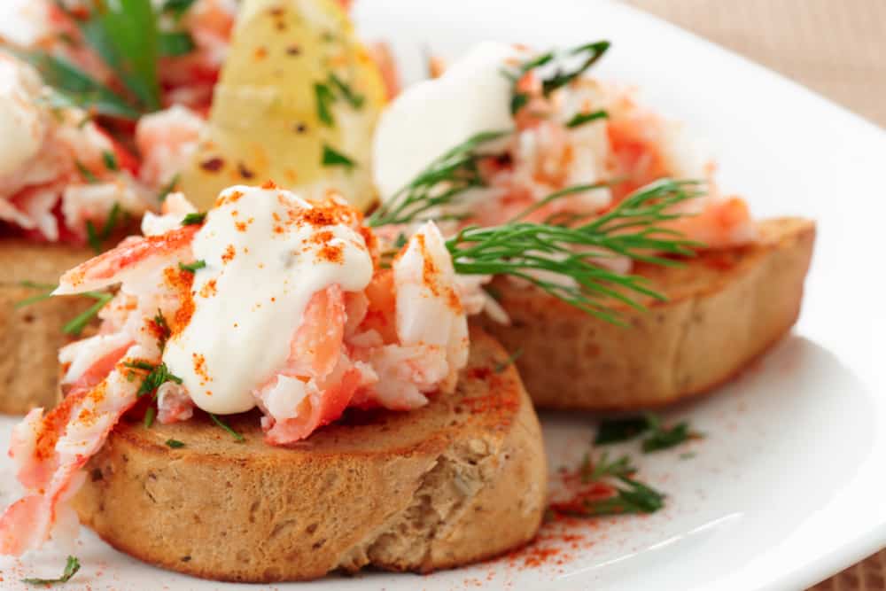 Close Up Of Crab Meat With Fresh Herbs On Top Of Toast