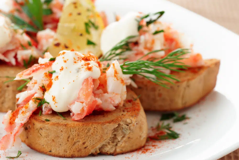 Close Up Of Crab Meat With Fresh Herbs On Top Of Toast