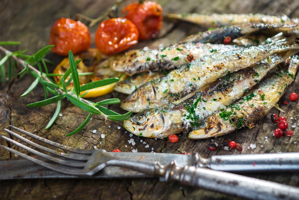 Grilled Sardines On A Wooden Table