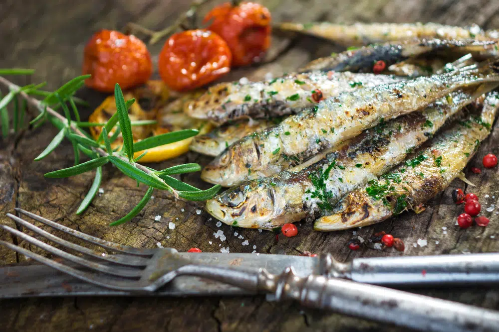 Grilled Sardines On A Wooden Table