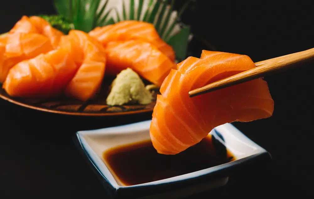 Salmon Sashimi Dipped Into Soy Sauce