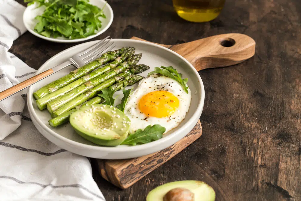 Healthy Homemade Breakfast With Asparagus, Fried Egg, Avocado And Arugula