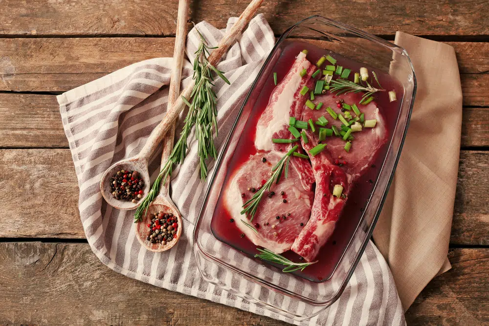 Marinating Meat With Spices And Red Wine Vinegar On Wooden Table