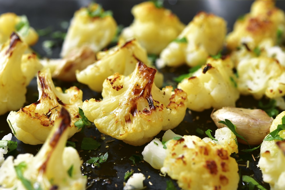 Oven Baked Cauliflowers On A Black Metal Background