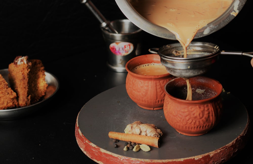 Traditional Chai Tea Or Masala Chai Being Poured In Earthen Cups Known As Kulhad