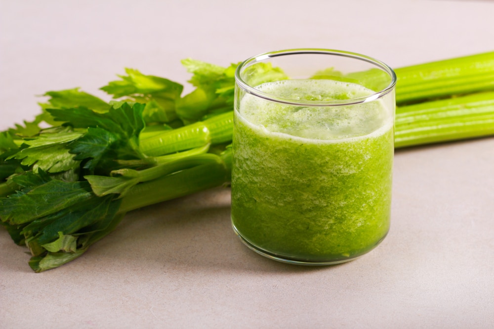Celery Smoothie And Celery Stalks On The Table