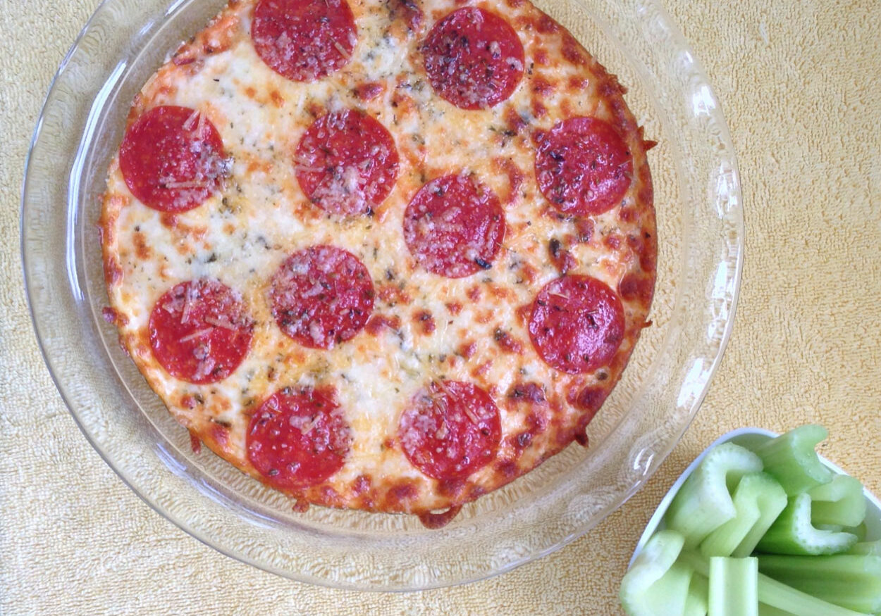 keto-low-carb-pizza-dip Creamy and zesty pizza dip that is topped with melted cheese and pepperoni. You won't miss the crust!